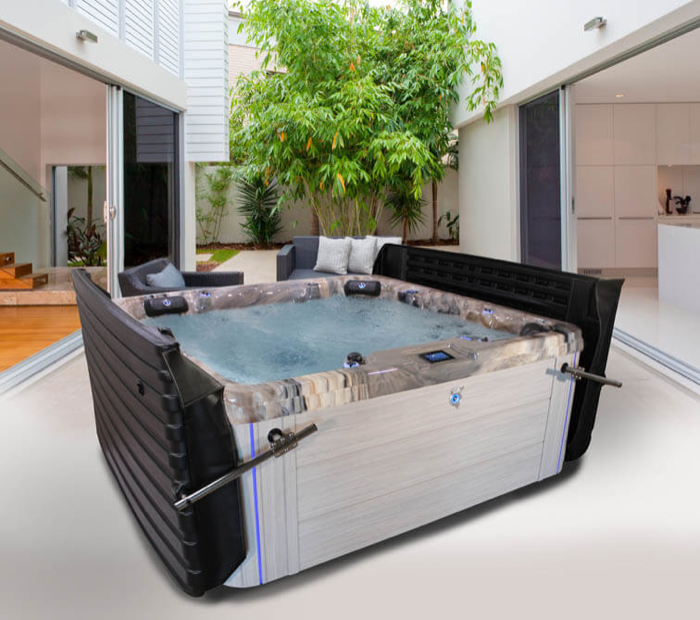 A modern hot tub with cover in a contemporary patio courtyard